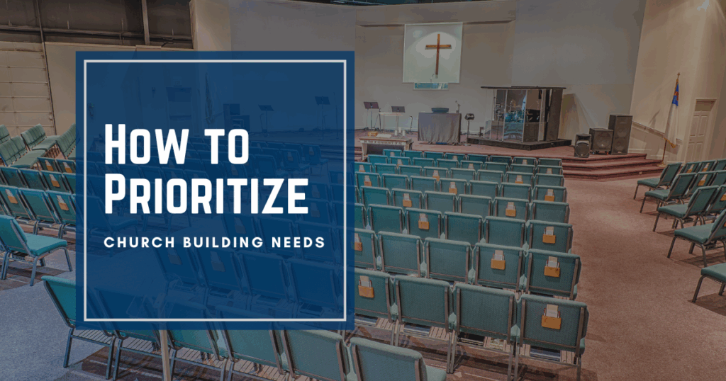 Church sanctuary with chairs lined up facing the stage with a cross on the wall in front.