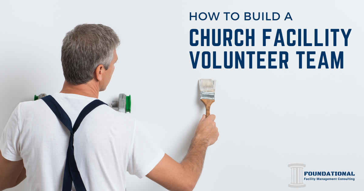 man on a ladder facing the wall and holding a paint brush