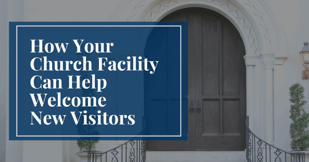 Wrought iron railings leading up stairs to a wood double door arch on the front of a white building