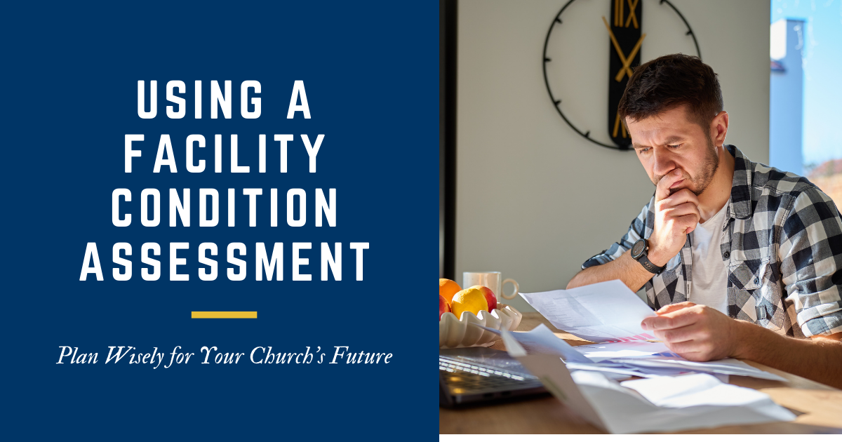 Man sitting at a desk in front of a laptop looking down at papers