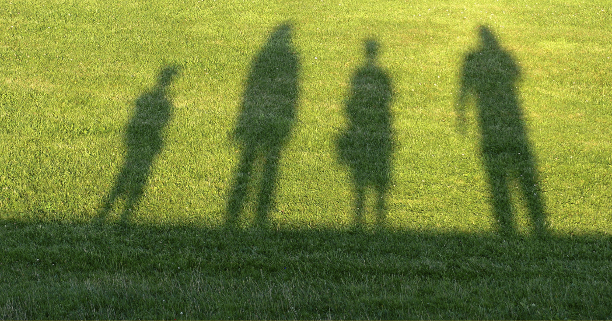 silhouettes on the grass of different sized people
